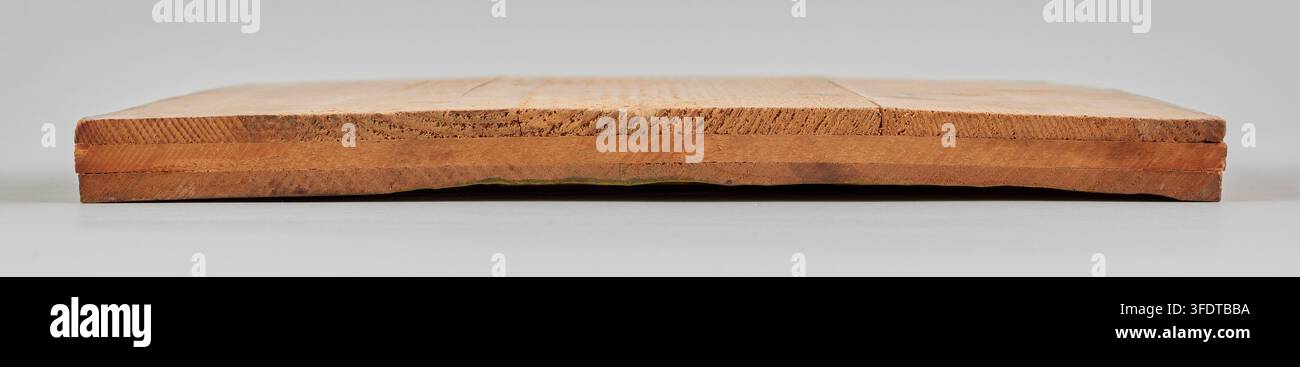 A rectangular wooden block, shown in side profile with a slightly ...