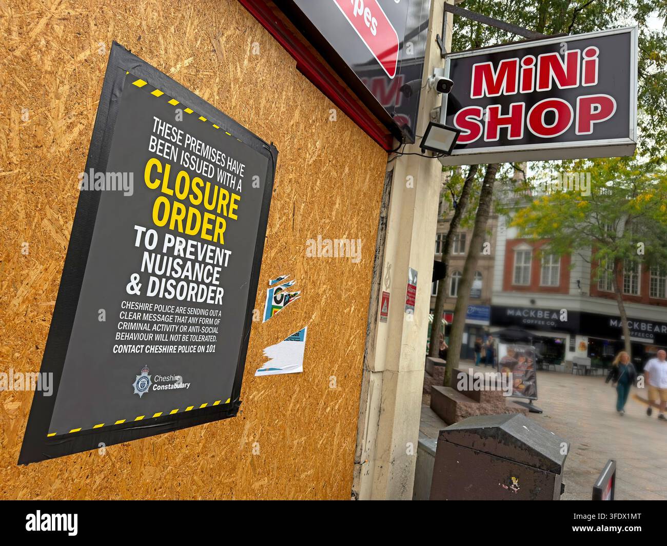 Police Closure Order on a boarded Mini Shop in Warrington, highlighting nuisance, disorder and enforcement against problem retail premises Stock Photo