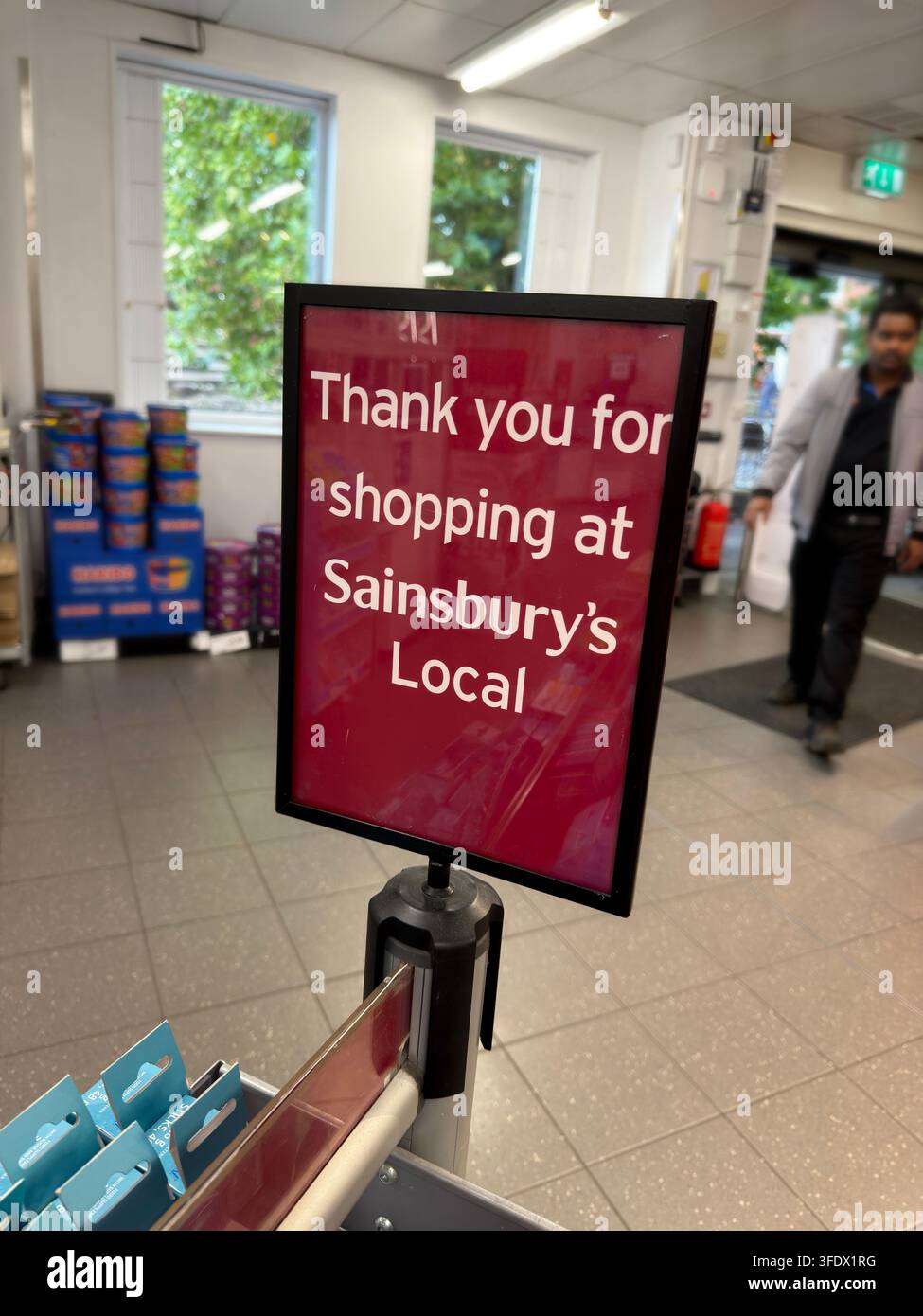 Sainsbury's Local checkout sign inside a UK convenience supermarket, reflecting the growth of small-format grocery stores on British high streets. Stock Photo