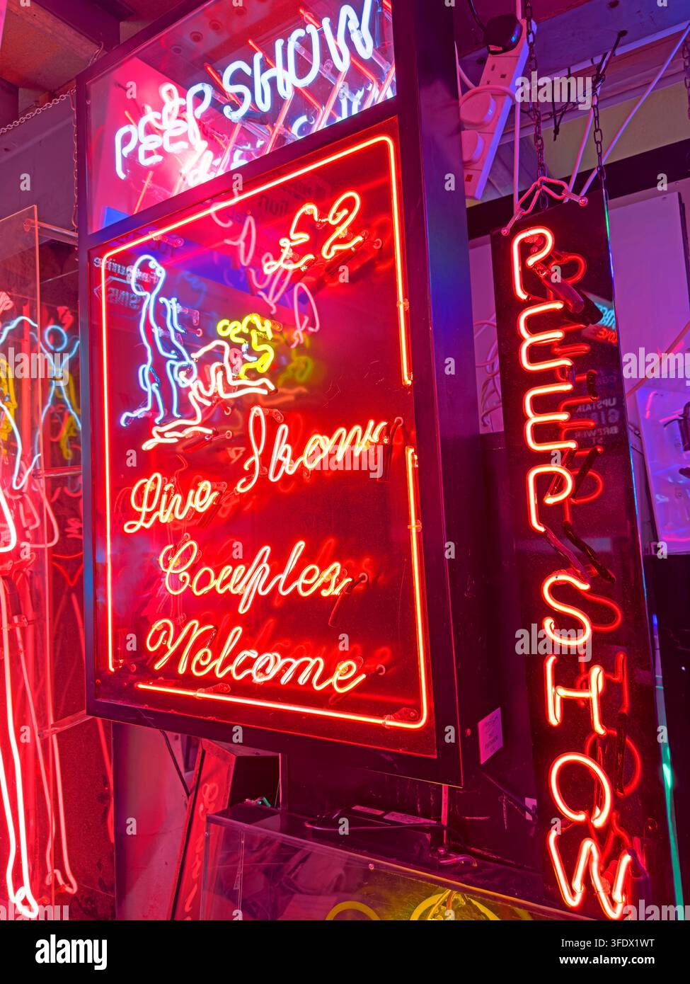 Peep show and adult entertainment neon signs glowing in Soho, central London Stock Photo