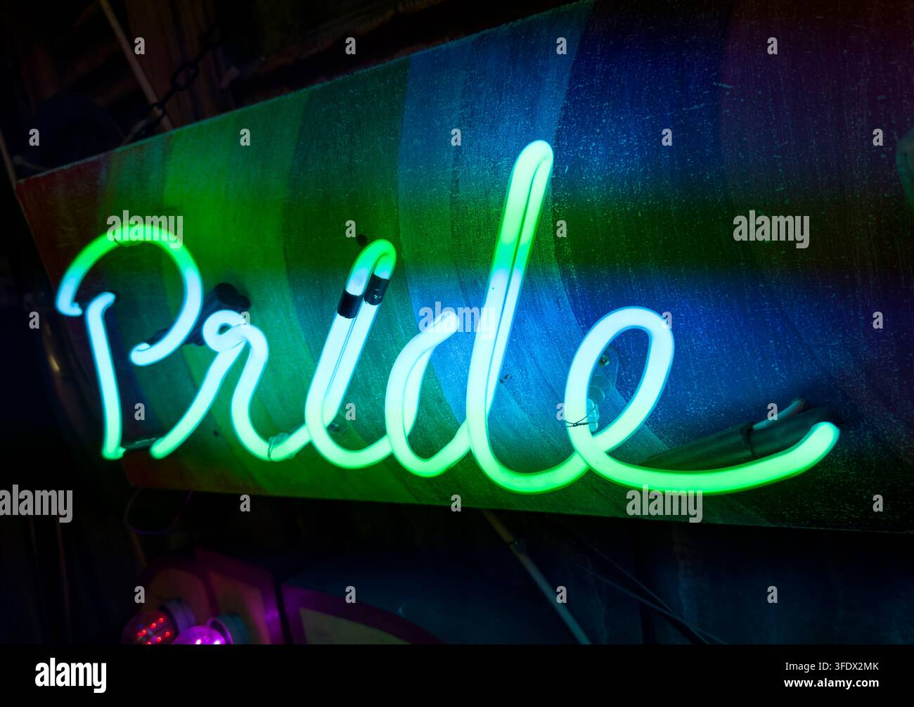 Pride neon sign glowing in rainbow colours, representing LGBT and LGBTQ+ identity, inclusion and celebration Stock Photo