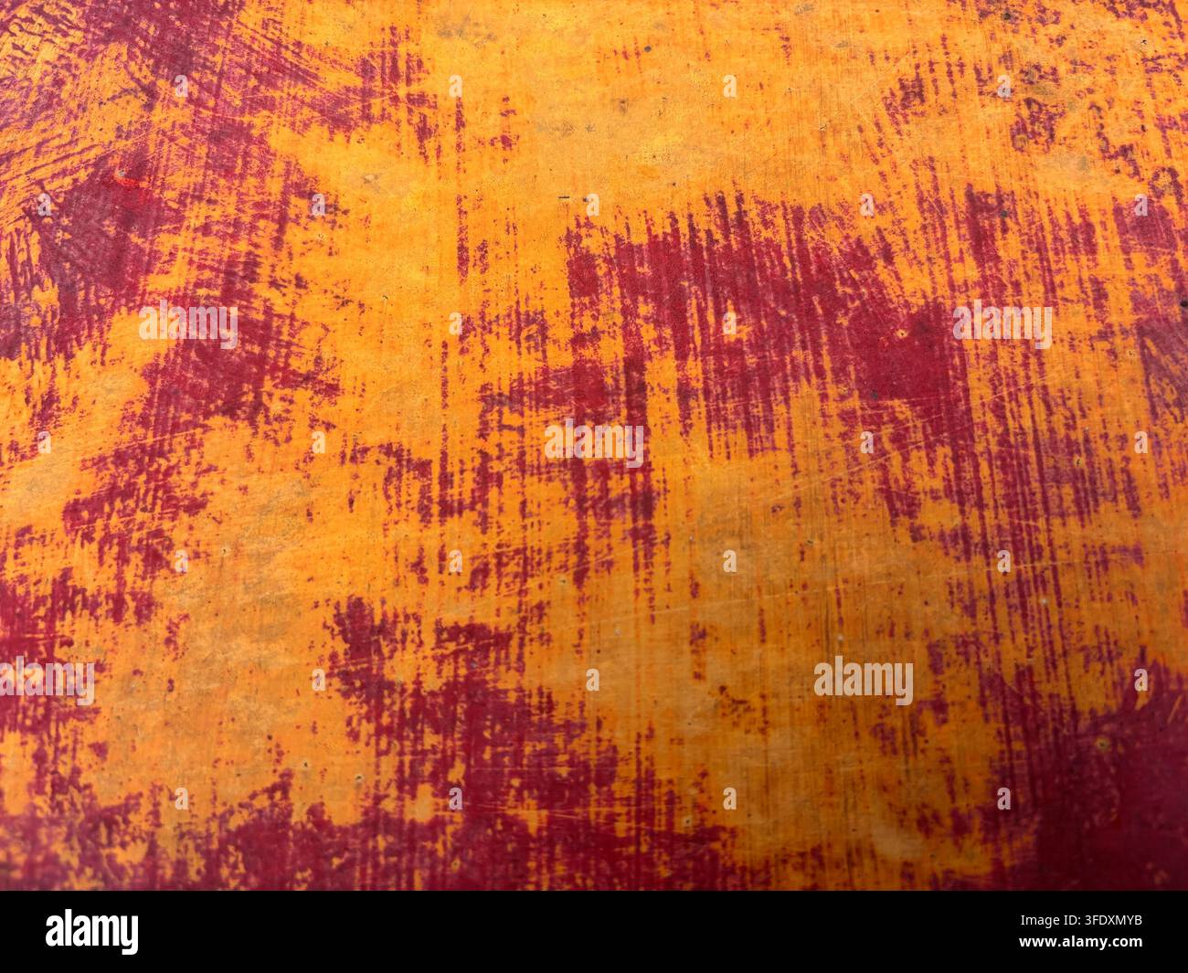 Old red and orange painted metal sheet for use as a background texture Stock Photo