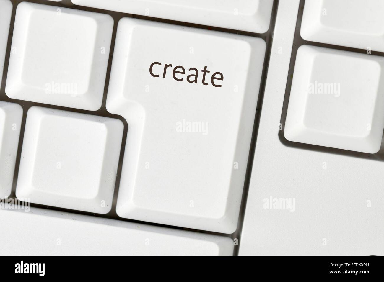 Enter key with create text symbolizing digital creativity and content production Stock Photo