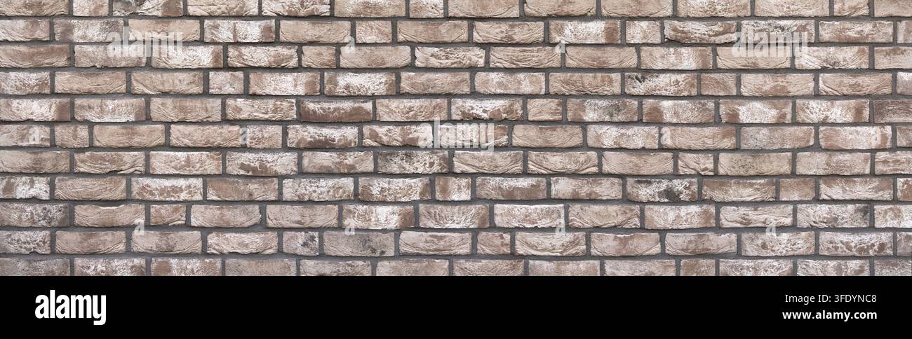 Wall panorama made of rectangular stones with abstract brown white pattern Stock Photo