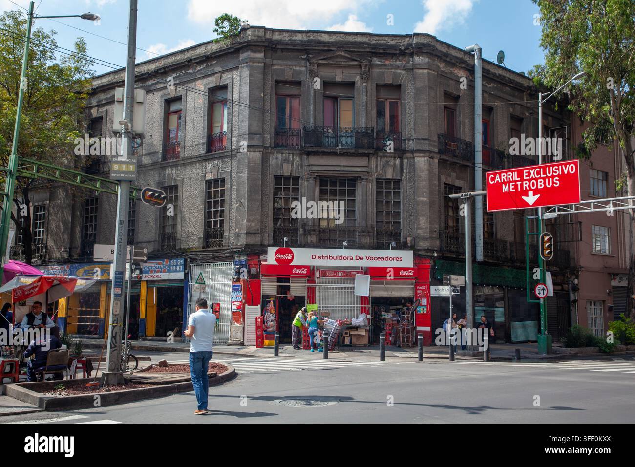 historic multi-story stone building on a city street corner in Mexico City, Stock Photo