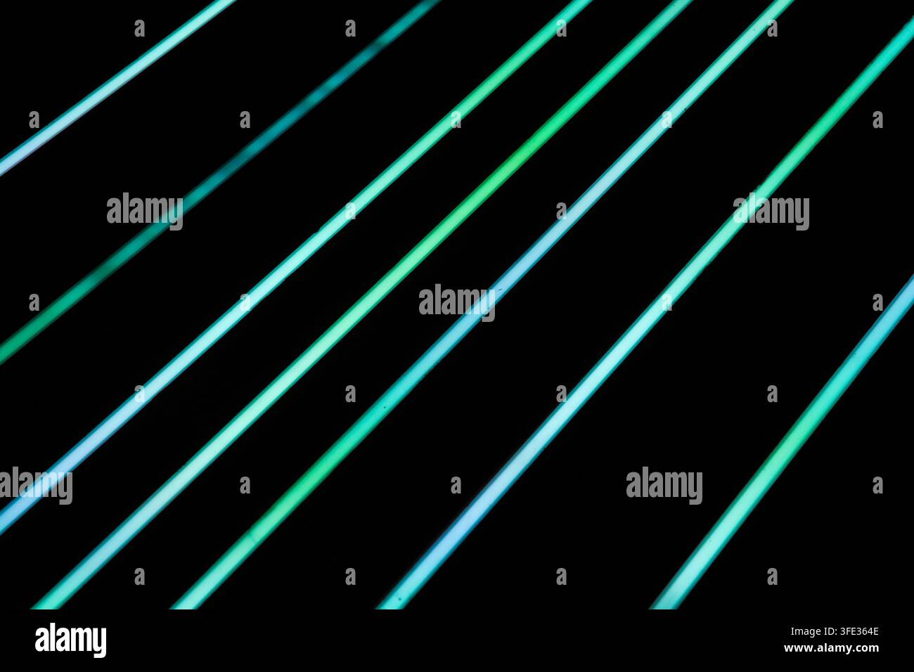 Glowing neon stripped lights on dark background Stock Photo