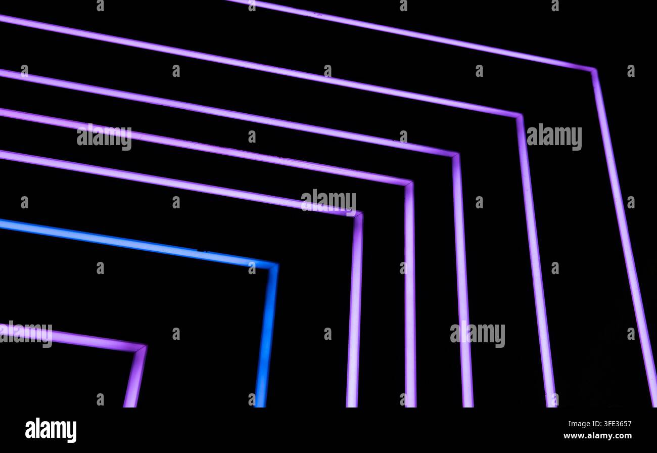 Glowing neon stripped lights on dark background Stock Photo