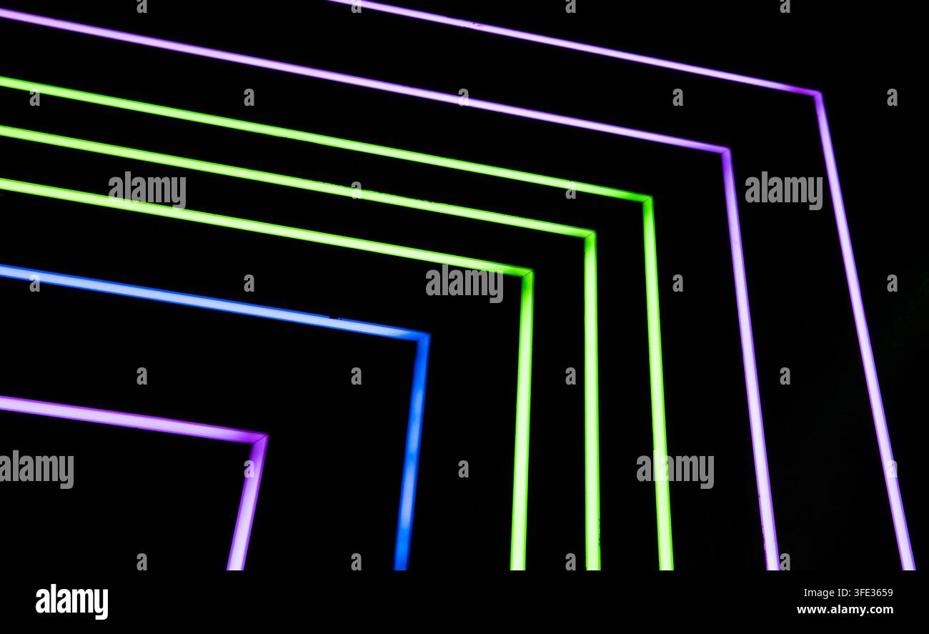 Glowing neon stripped lights on dark background Stock Photo
