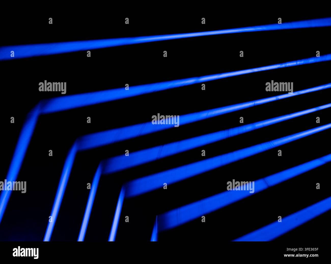 Glowing neon stripped lights on dark background Stock Photo
