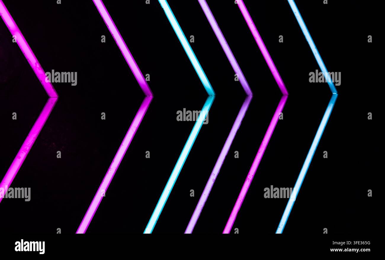 Glowing neon stripped lights on dark background Stock Photo