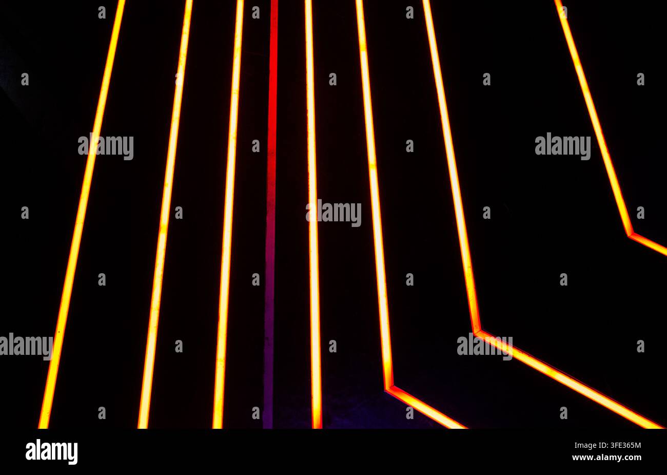 Glowing neon stripped lights on dark background Stock Photo