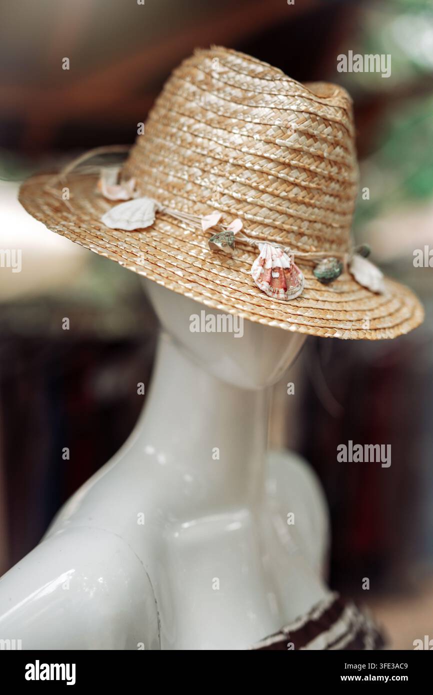Summer straw hat with seashells on a mannequin puppet Stock Photo