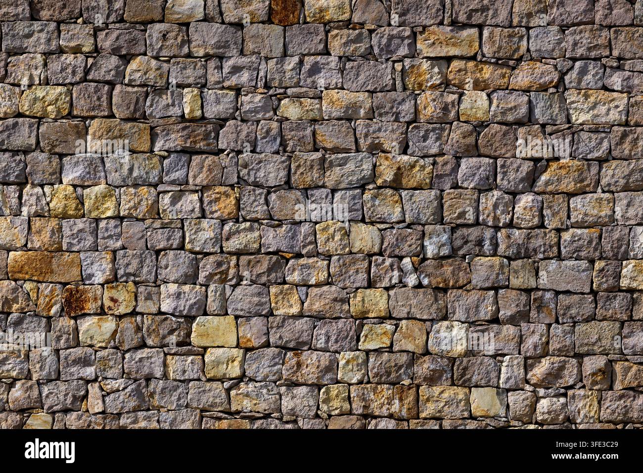 Old rustic stone wall texture background Stock Photo