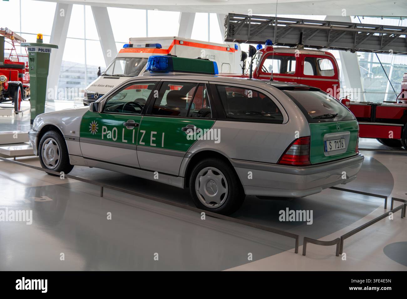 Stuttgart, Germany - 13 Feb 25: Green and silver Mercedes-Benz police car displayed among emergency vehicles in the Stuttgart museum. Stock Photo