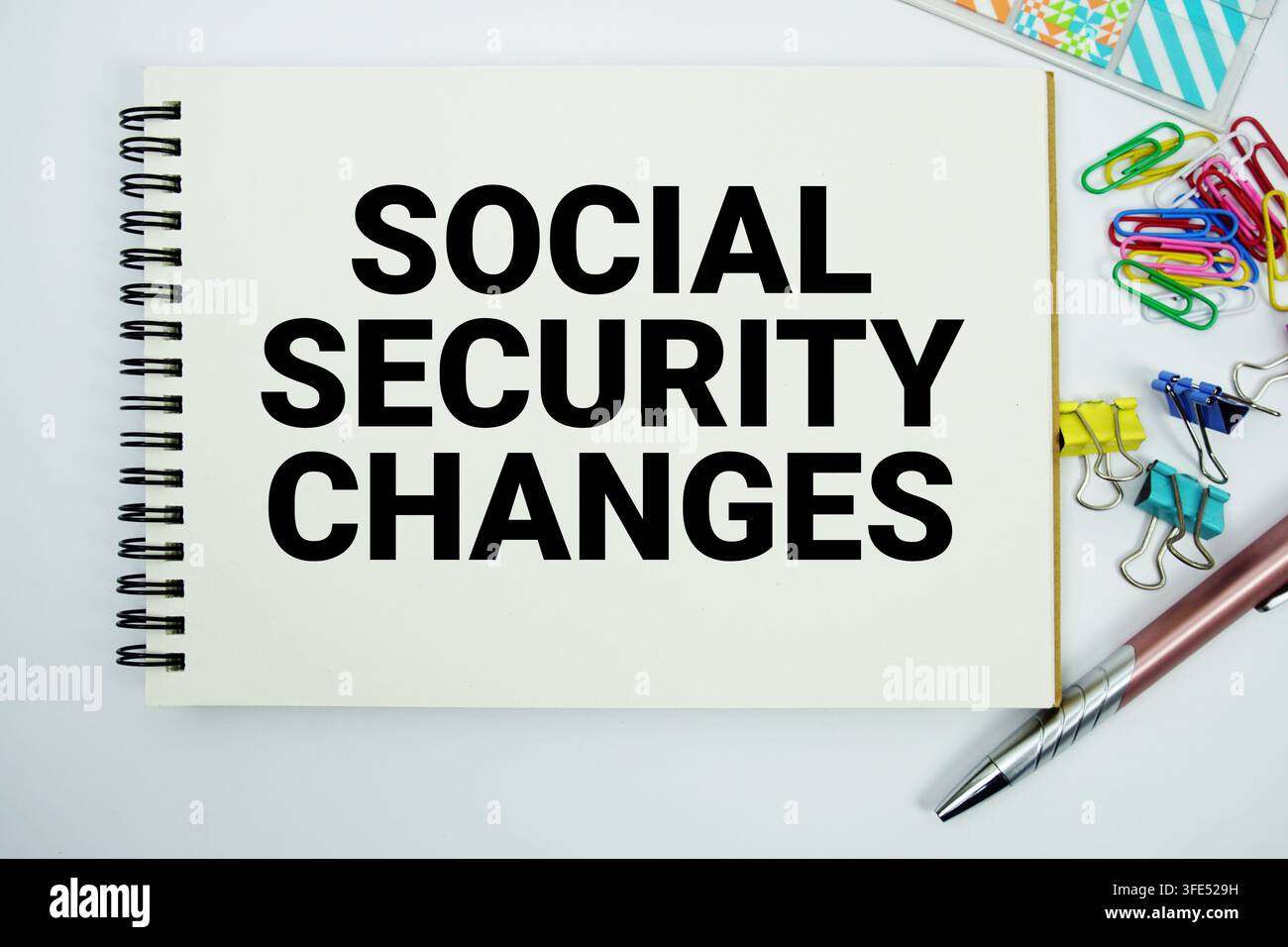 Social Security Changes text message written on notepad with stationery flat lay on white background Stock Photo