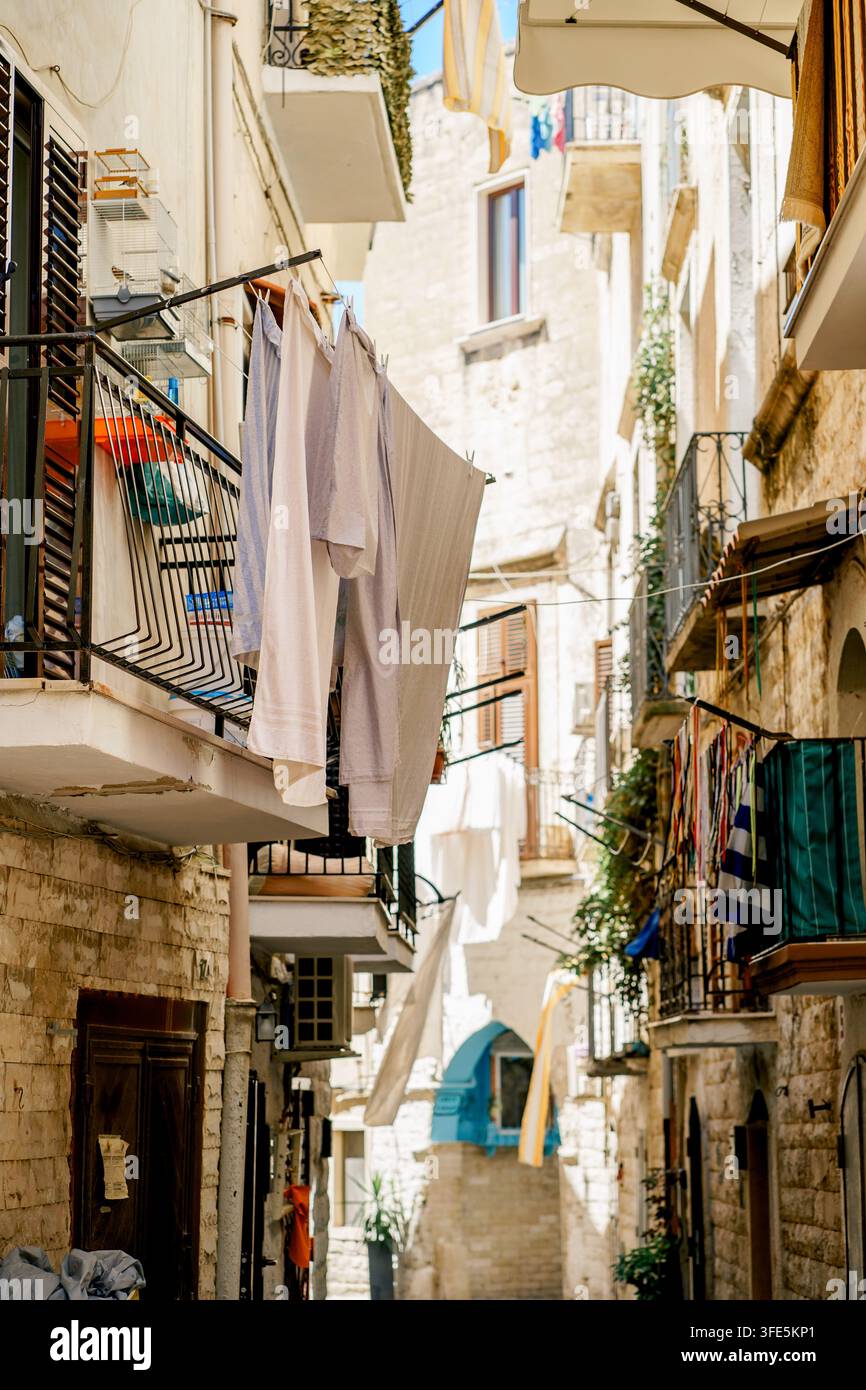 laundry-hangs-above-a-historic-alley-with-limestone-houses-in-bari