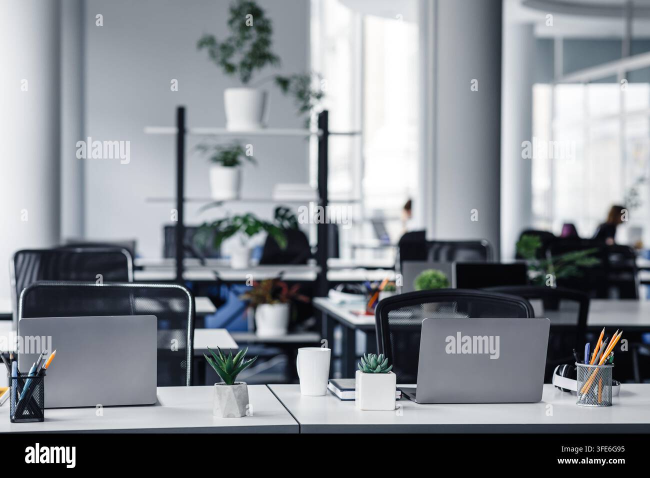 Office interior with white columns and panoramic windows in modern loft Stock Photo