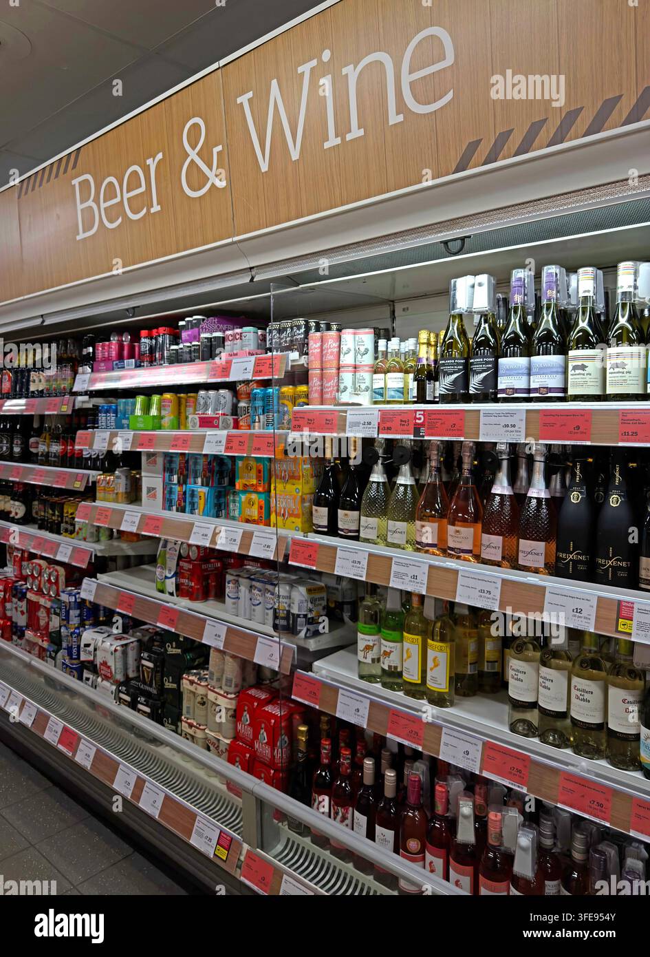 Supermarket beer and wine aisle, as cheaper take-home alcohol competes with pubs and hospitality for consumer spending in UK, England & Scotland Stock Photo