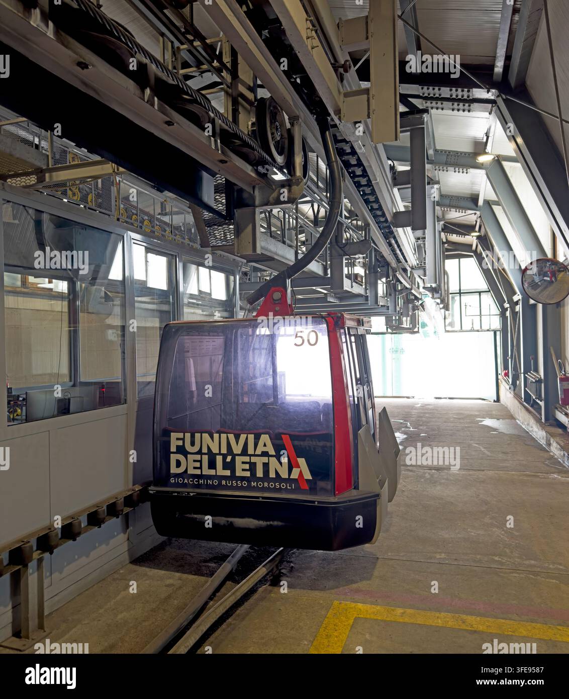 A Funivia dell'Etna gondola passes through the cable car station on Mount Etna, Catania, Sicily, Italy, carrying tourists up the volcano. Stock Photo