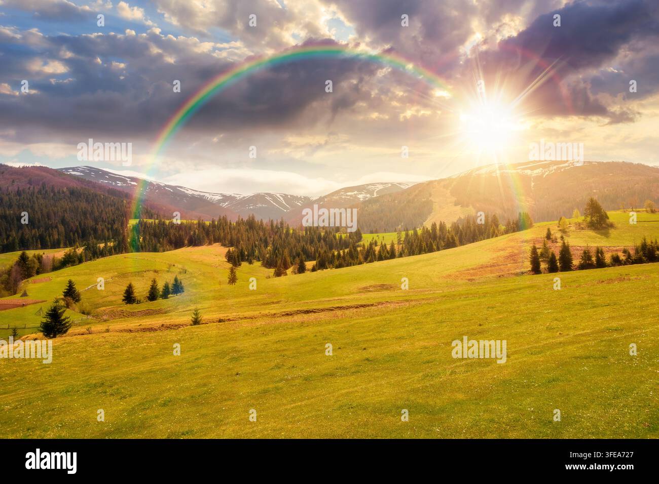 sunset over panoramic view of countryside of Ukraine. wonderful springtime landscape in Carpathian mountains. grassy field and rolling hills. beautifu Stock Photo