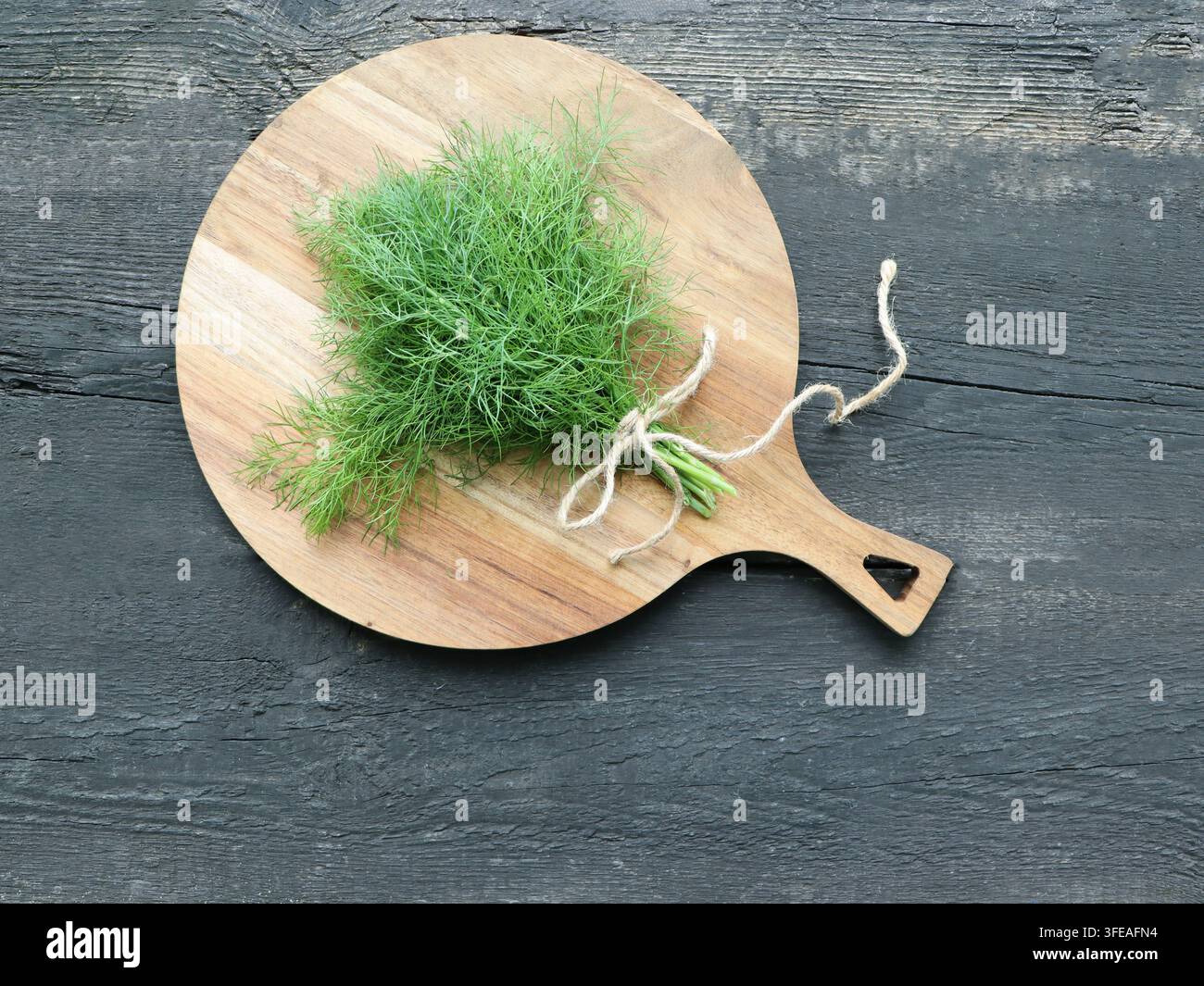 Fresh Dill Bunch on Wooden Cutting Board Stock Photo