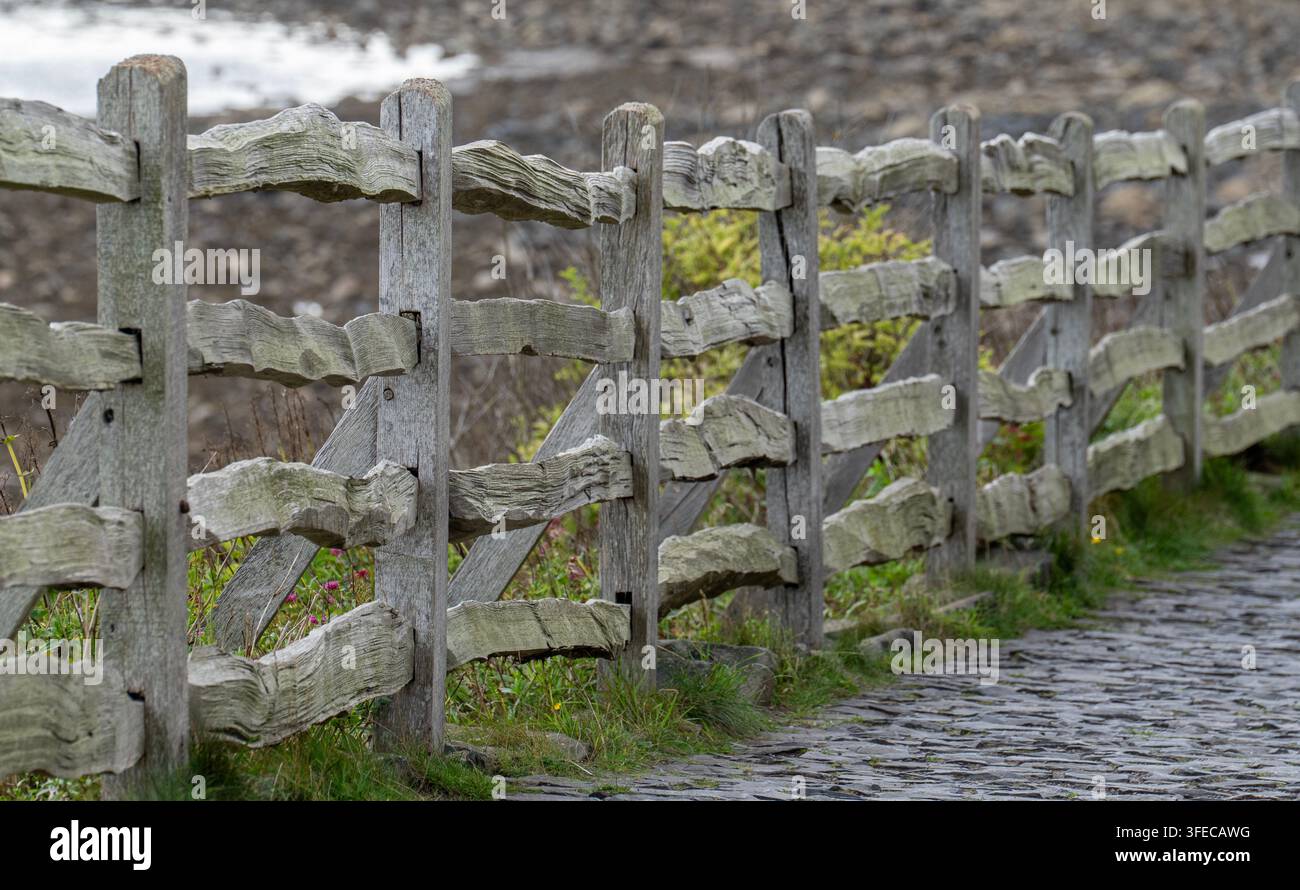 Old rustic wooden fence and sone path Stock Photo