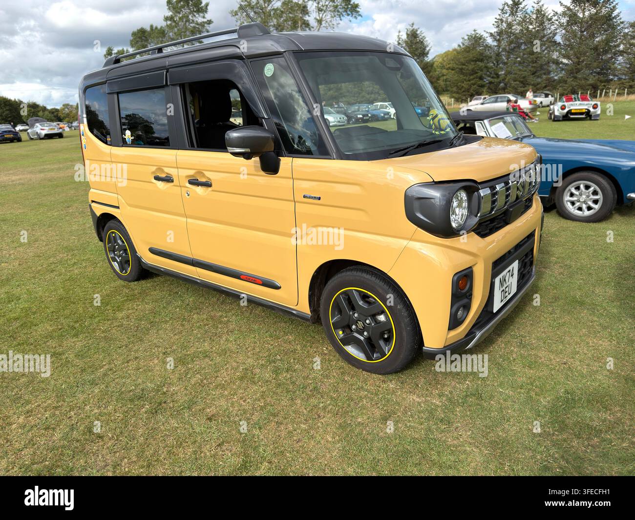 Yellow Suzuki Spacia Gear kei car with Minions stickers at a United Kingdom car show - Smartphone Captured Stock Image