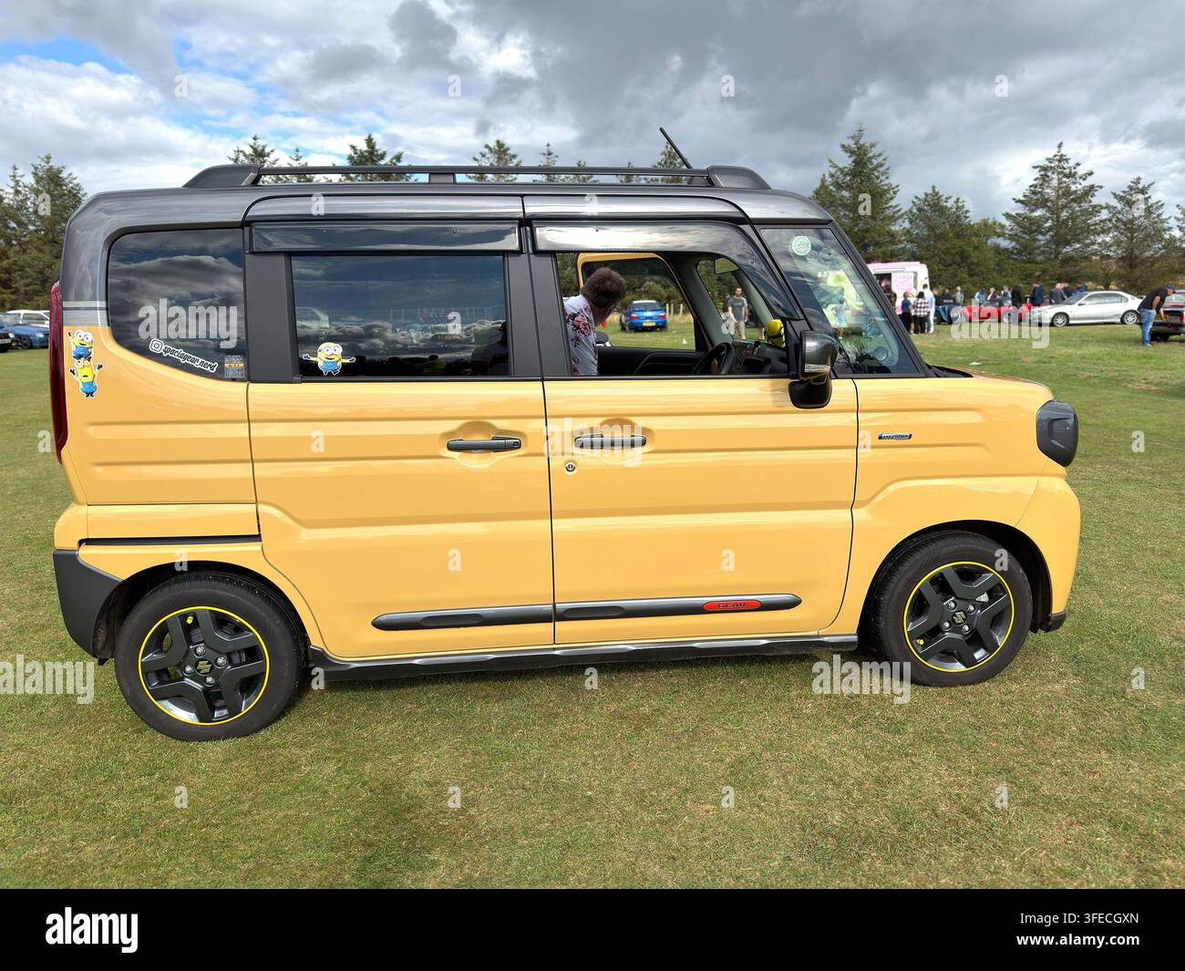 Yellow Suzuki Spacia Gear kei car with Minions stickers at a United Kingdom car show - Smartphone Captured Stock Image