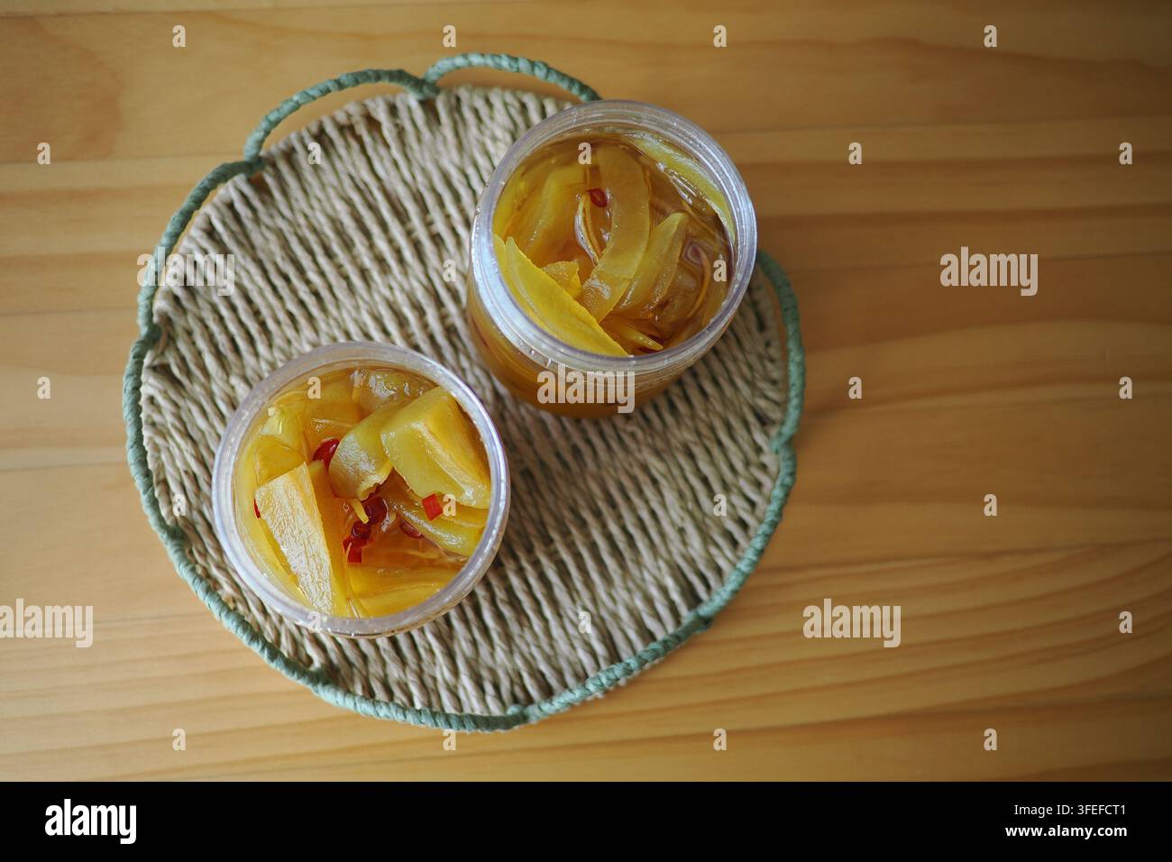 show small plastic jars filled with homemade fruit preserves or jam, Stock Photo