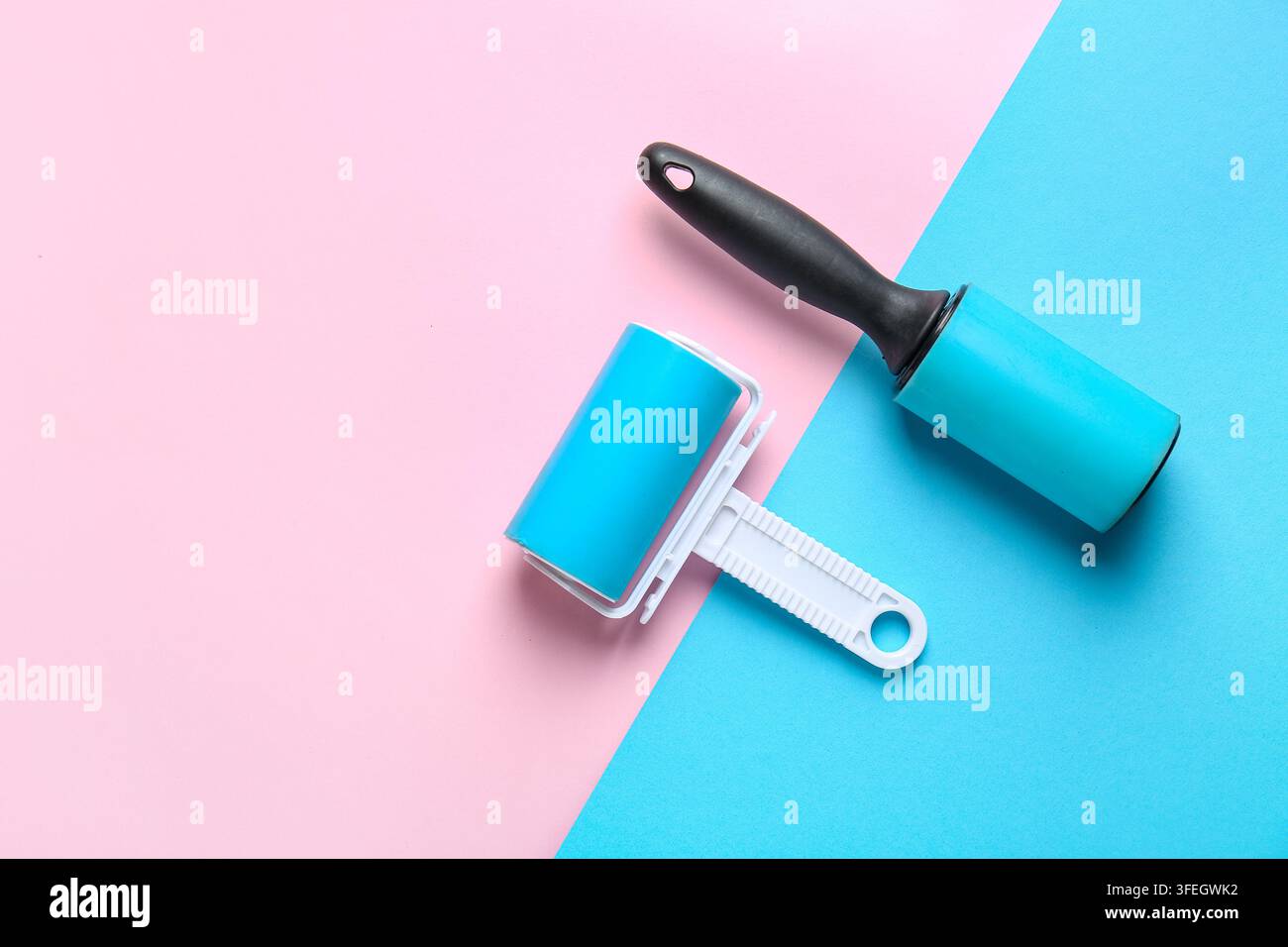 Different lint rollers on color background Stock Photo
