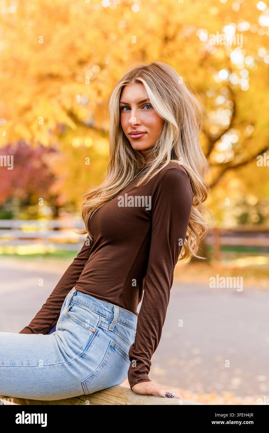 Stylish young woman posing on a beautiful fall day Stock Photo