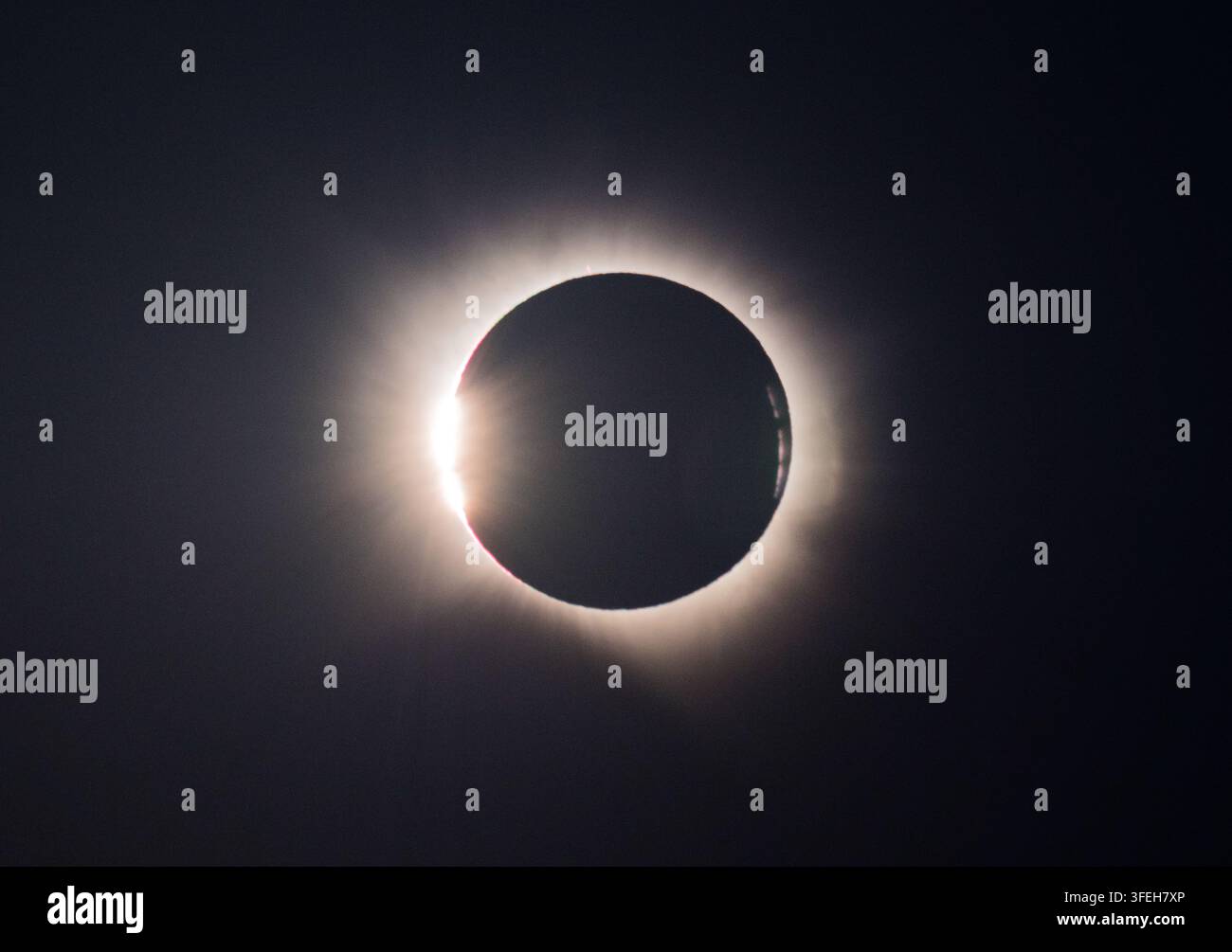 Baily's Beads Shining Around the Moon During Total Solar Eclipse Stock Photo