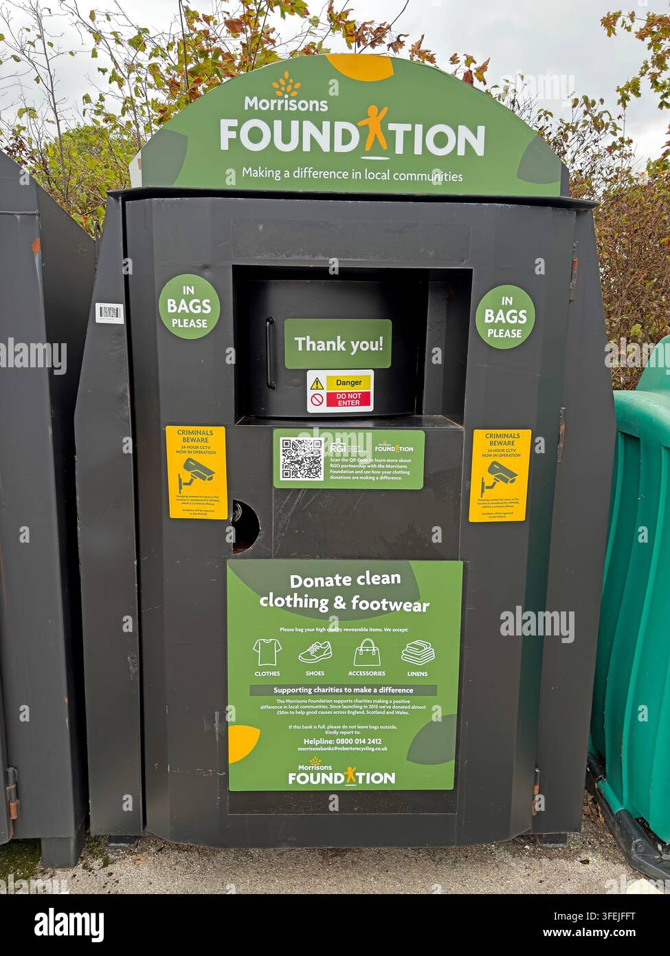 Clothes and footwear recycling bank supporting the Morrisons Foundation outside a supermarket. Stock Photo