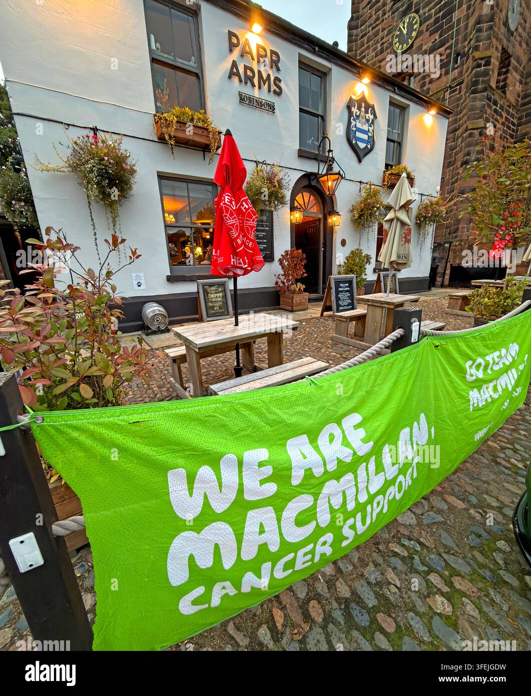 Robinsons Parr Arms pub in Grappenhall displays a Macmillan Coffee Morning fundraising banner ahead of the charity's September 2026 event Stock Photo