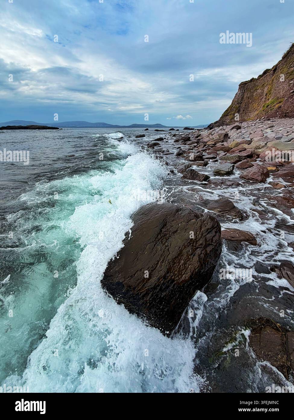 Wave breaking on the shoreline of Ireland at Toor beach, Kilcrohane, Ballinskelligs Bay, County Kerry, Ireland. - Smartphone Captured Stock Image