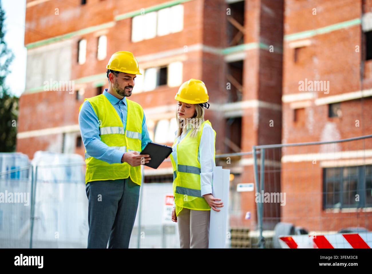 Construction engineers working on building site planning Stock Photo