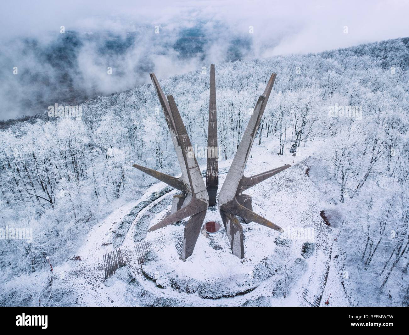 January 3, 2026, Kosmaj, Serbia: Aerial top-down view of the partisan monument encircled by snow-laden forest Stock Photo