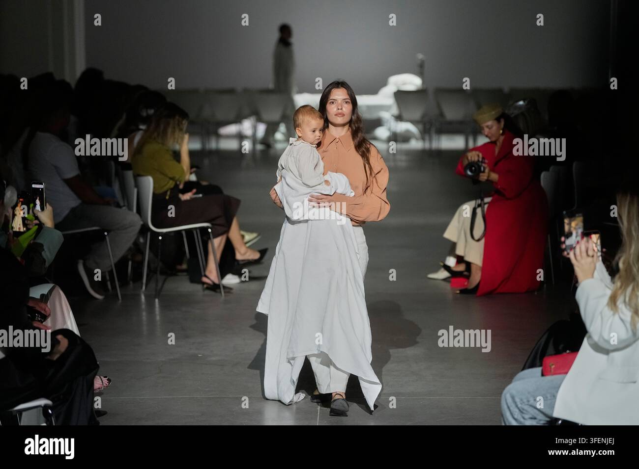 - frontend development important topics 📲 @ ... A model holds a baby as she wears a creation by designer Przhonska ...