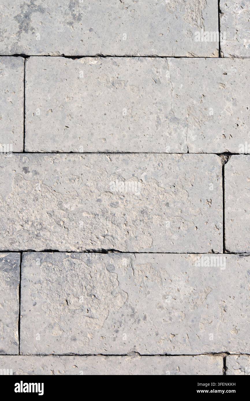Light Gray Limestone Block Wall Texture with Natural Stone Pattern and Weathered Surface Stock Photo