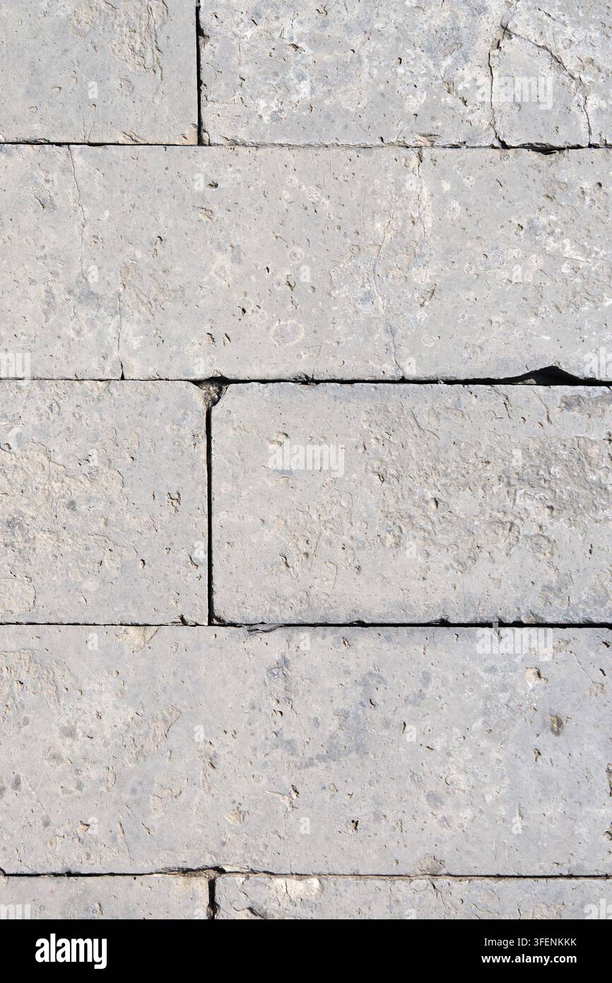 Natural Gray Limestone Wall Texture with Weathered Masonry Block Pattern Background Stock Photo