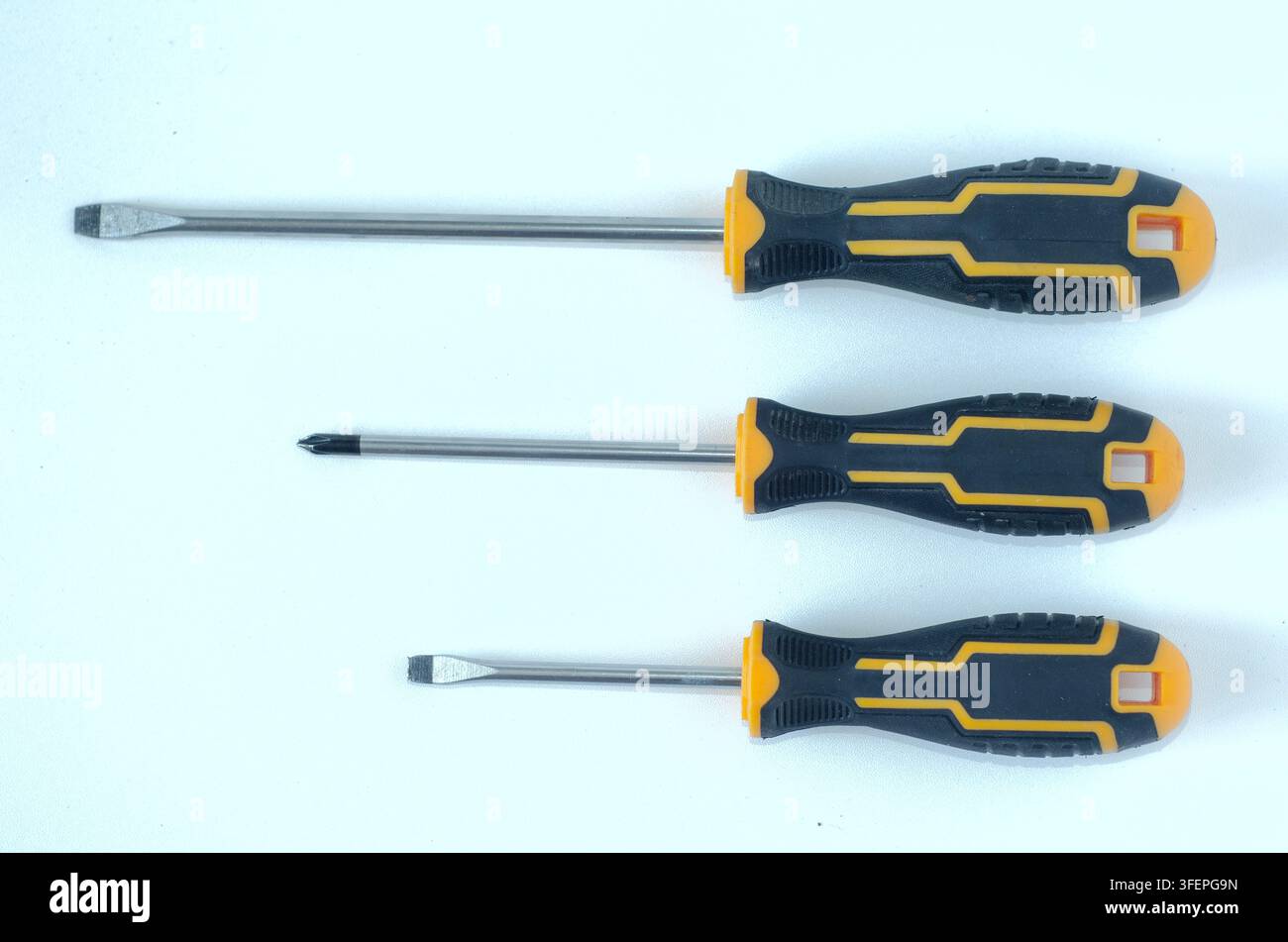 Assorted Screwdrivers on White Background Top View Stock Photo