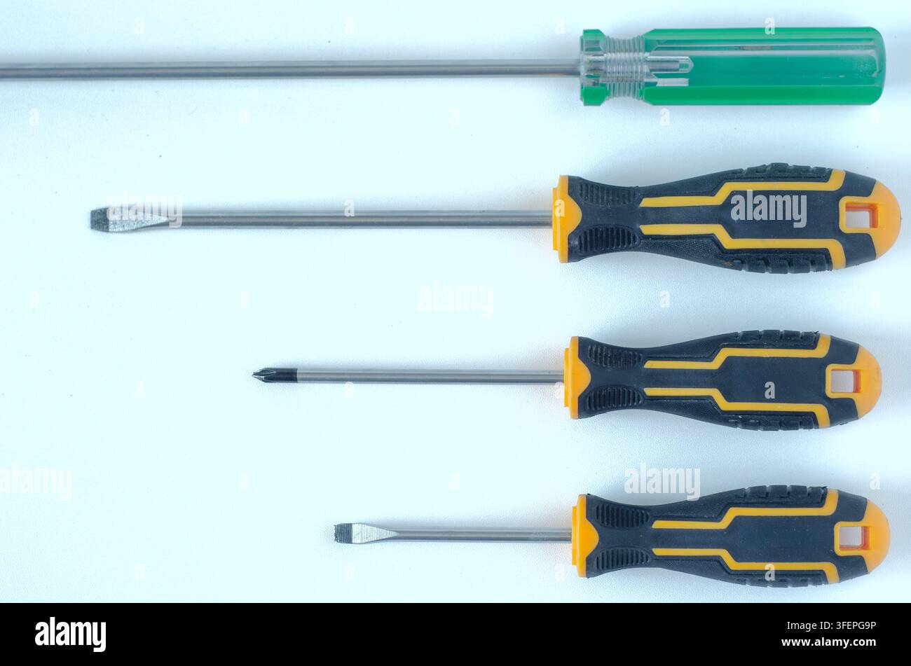 Assorted Screwdrivers on White Background Top View Stock Photo
