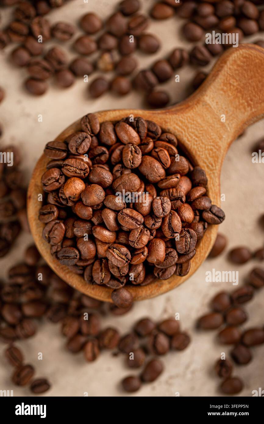 Roasted coffee beans in rustic wooden scoop Stock Photo
