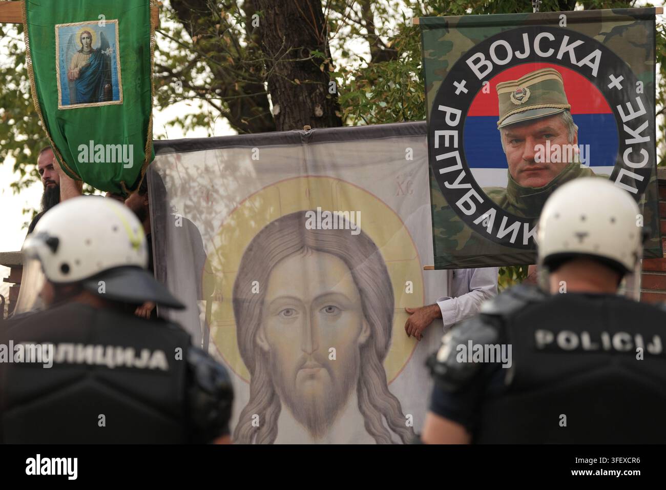 serbian-police-officers-guard-christian-orthodox-believers-wave-a-flag