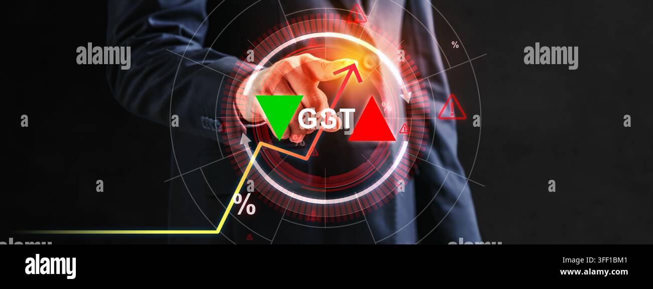 A businessman in a suit interacts with a futuristic digital interface showing GST text, percentage symbols, and upward and downward trend arrows repre Stock Photo