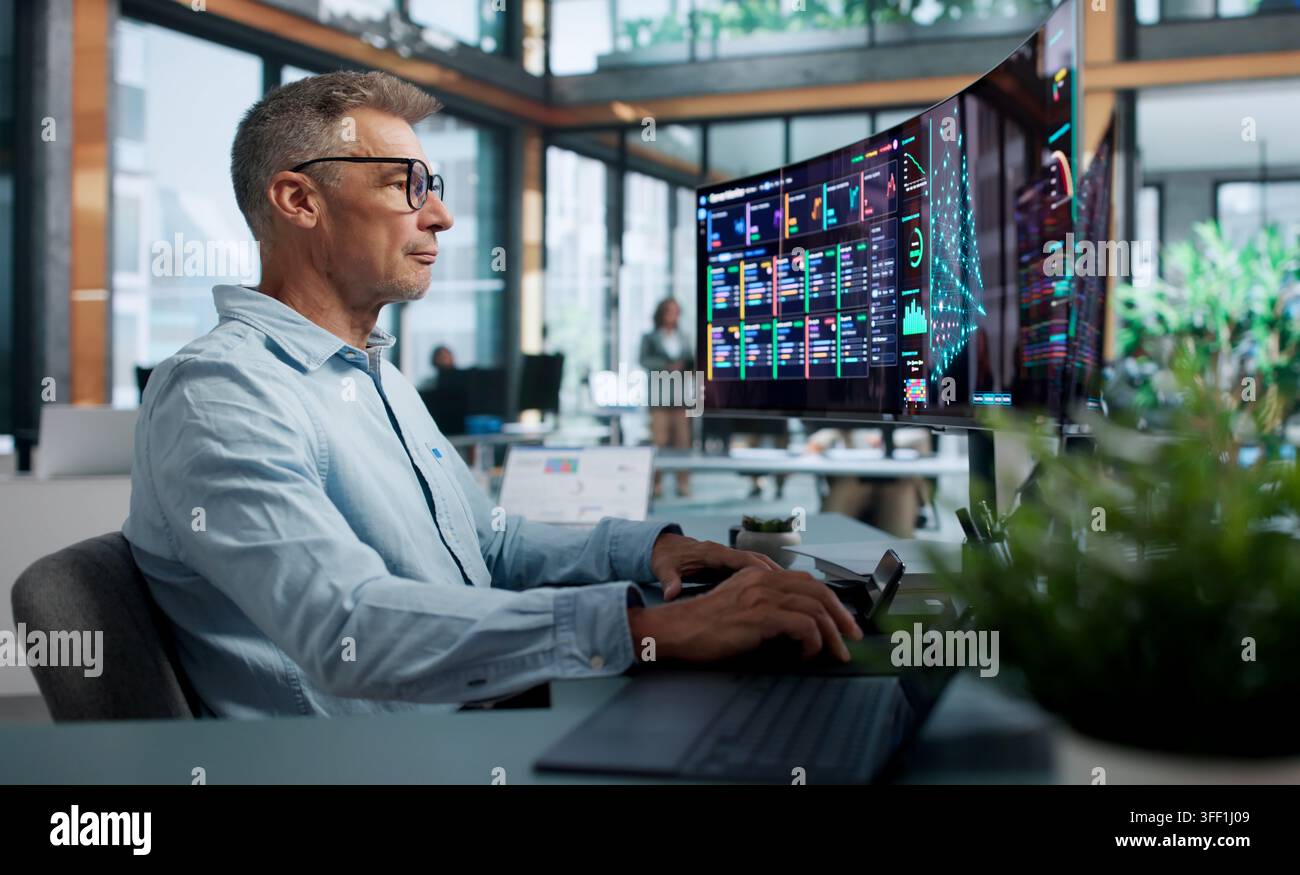 Data Scientist Carefully Analyzes Neural Network Models Using Dual Touchscreen Laptops. Stock Photo