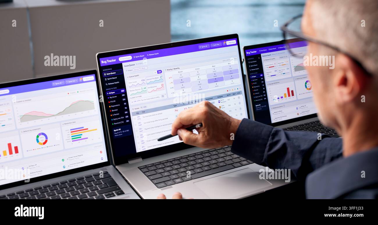 Software Developer Reviews Bug Tracking Dashboard To Prioritize Issue Resolution Tasks. Stock Photo