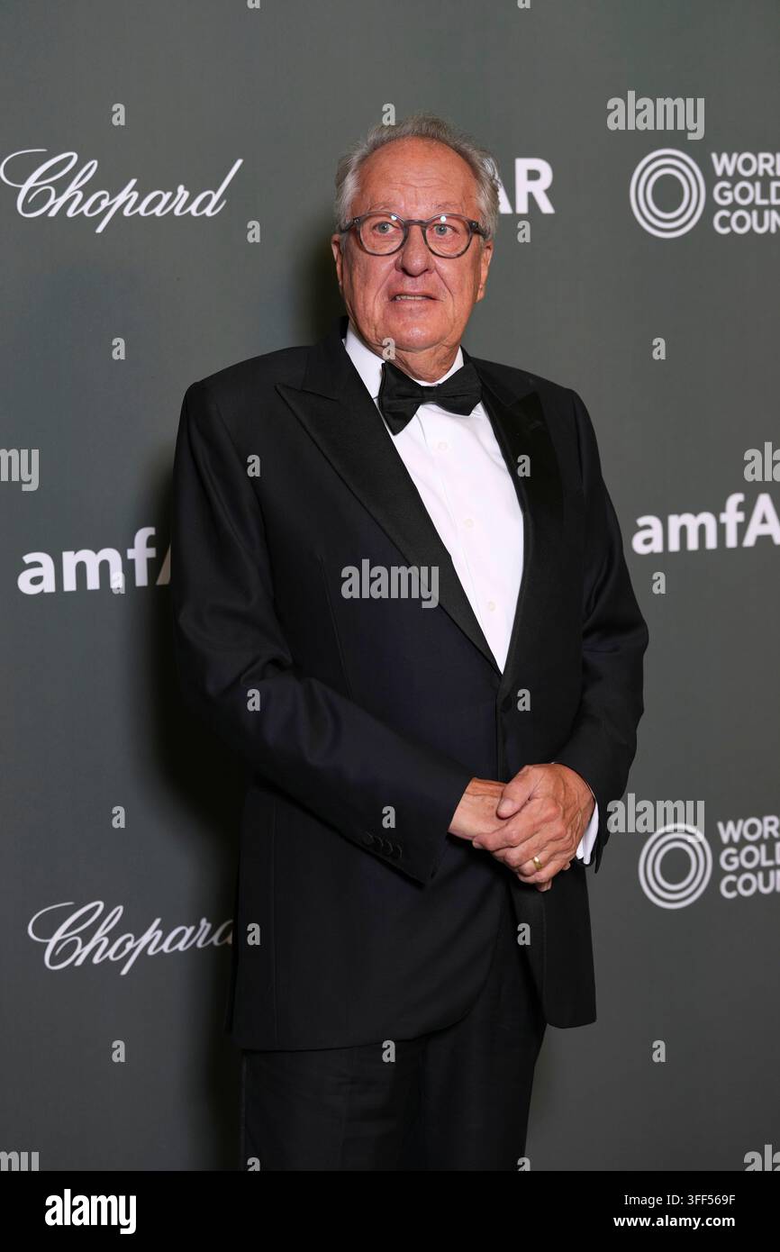 Geoffrey Rush poses for photographers upon arrival at the amfAR ...