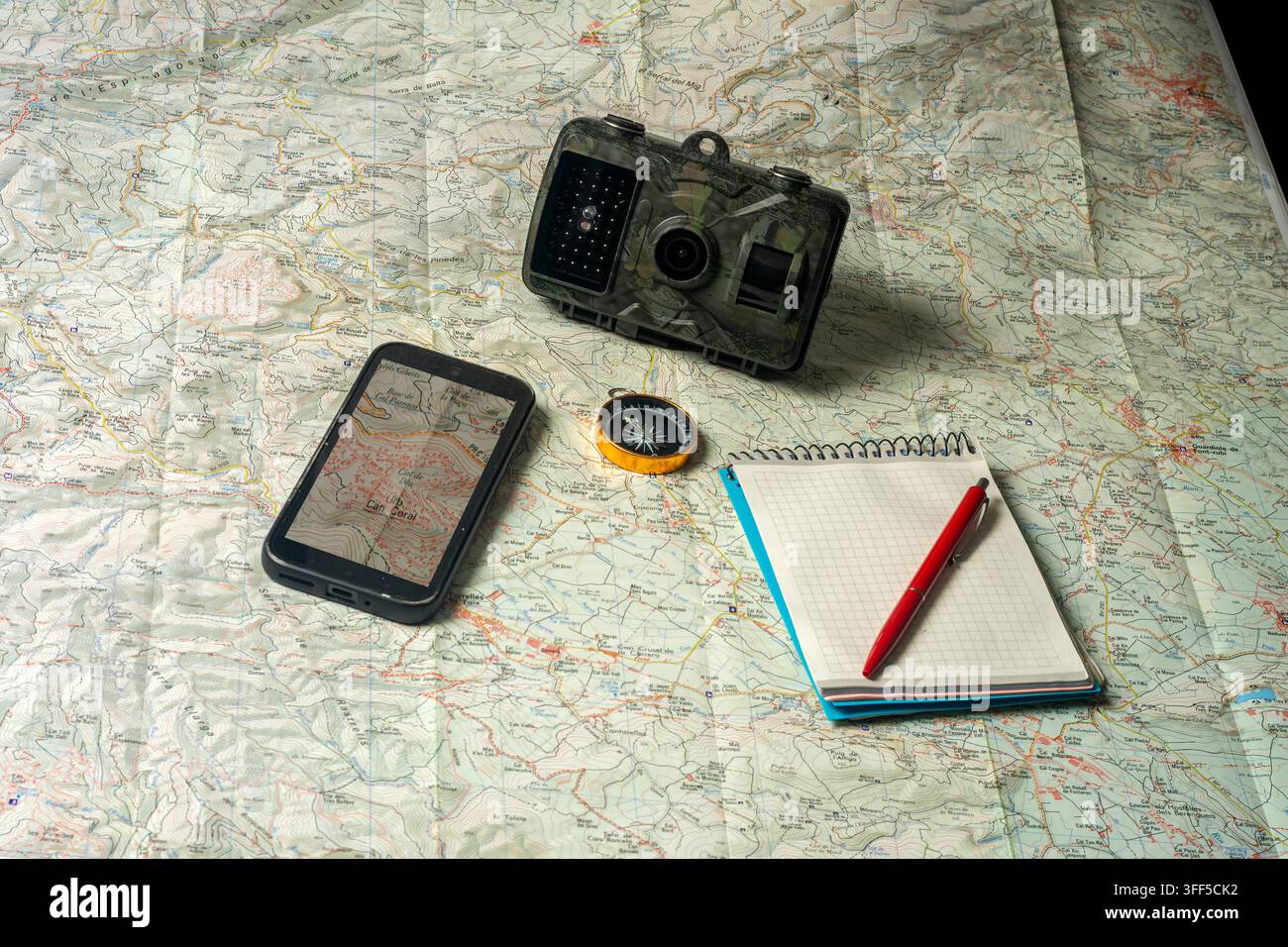Planning an outdoor adventure using map and technology Stock Photo