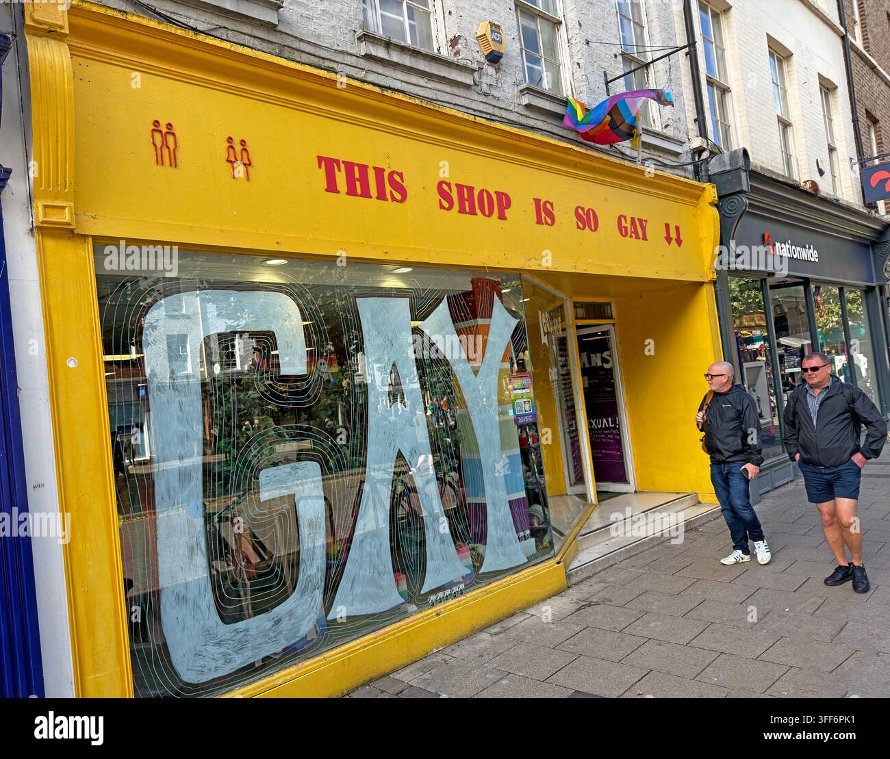 Bright yellow frontage of This Shop Is So Gay at 16 Parliament Street, York, an LGBTQ+ gift shop in the city centre. Stock Photo